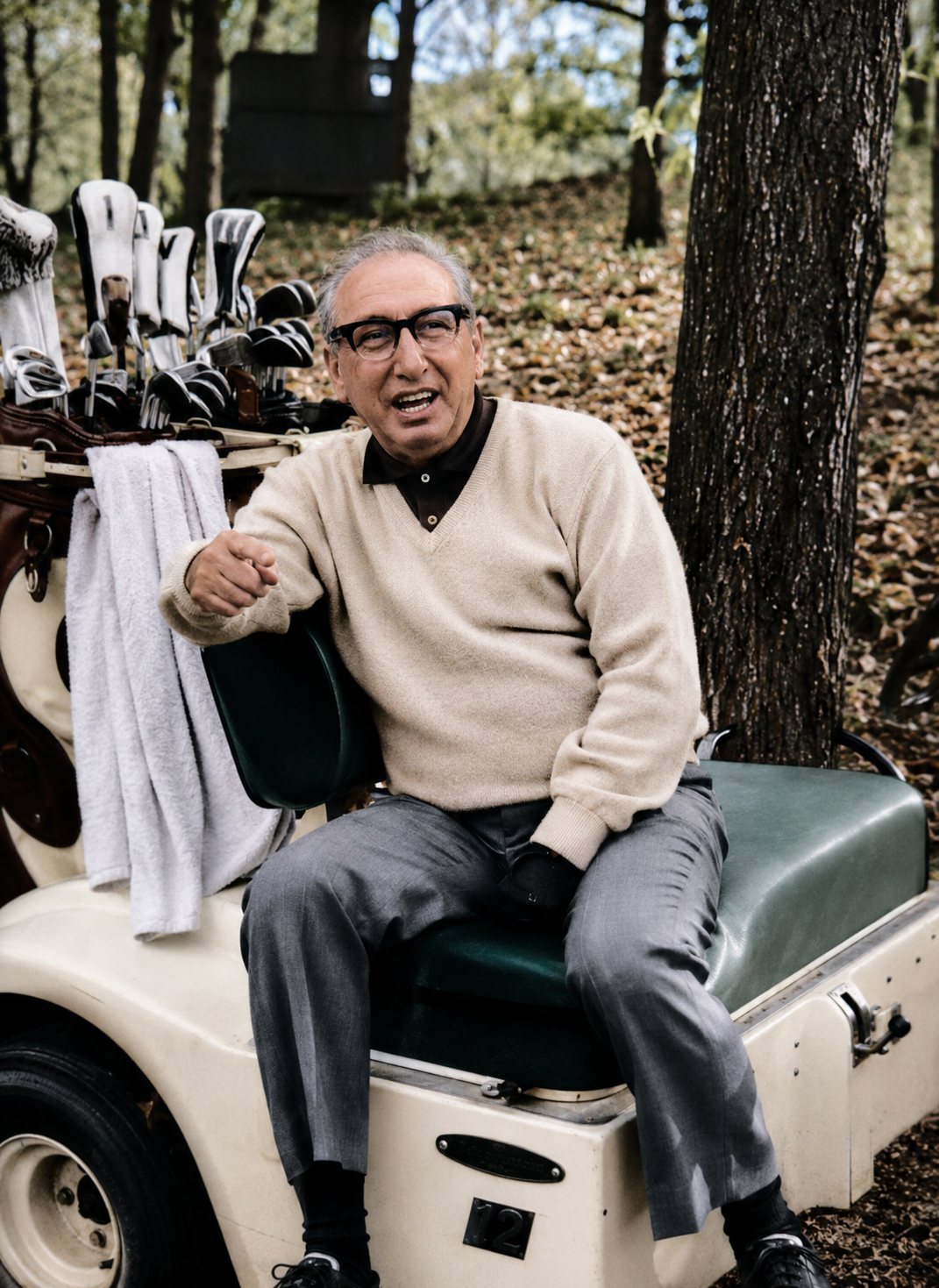 Peter Green seated on a golf cart beside golf clubs